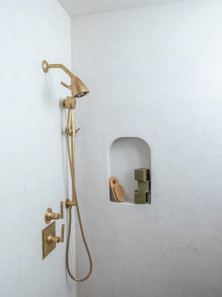 Gold shower fixture in bathroom